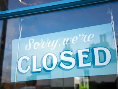 Close up of store closed sign saying sorry, were closed